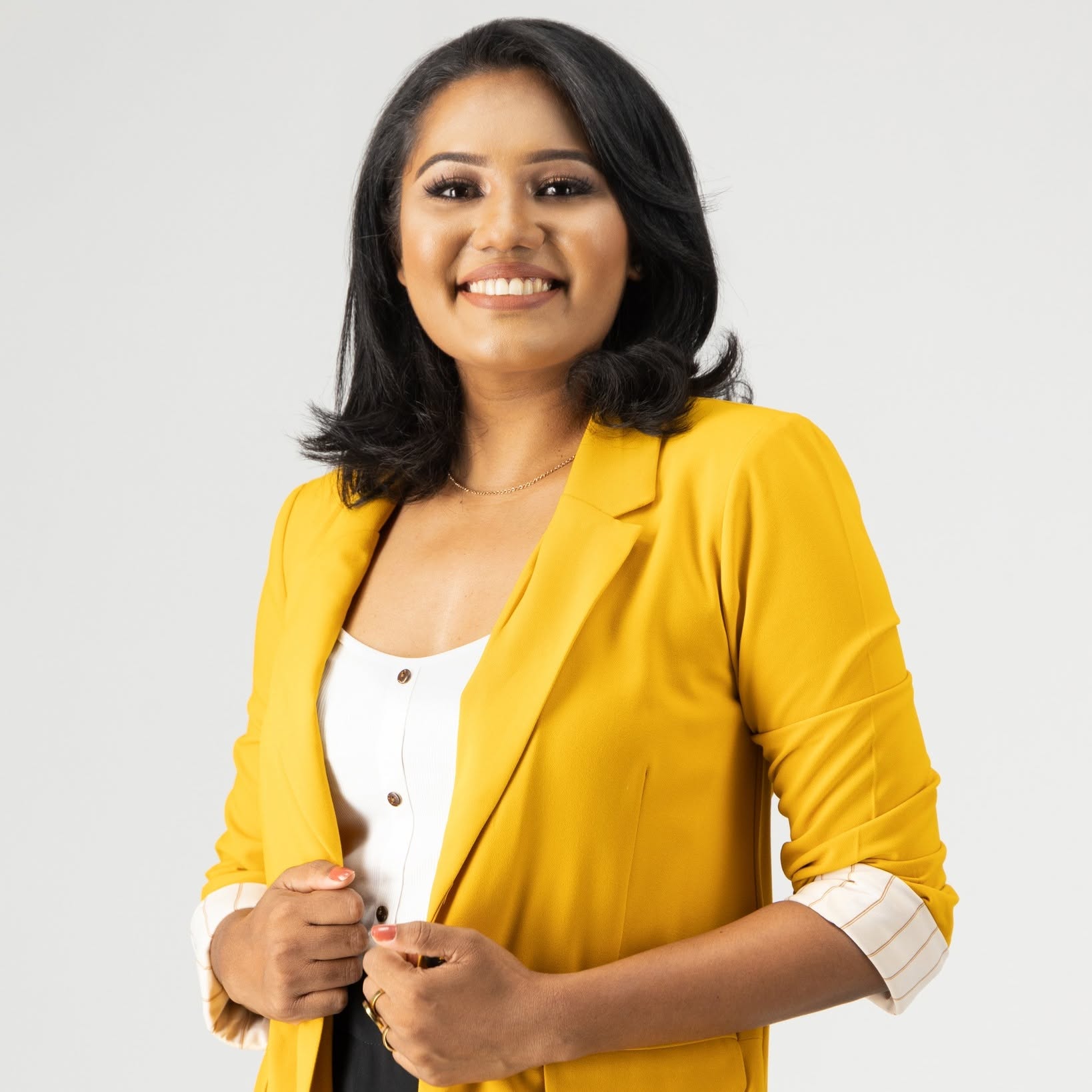 Lahiruka Weeraratna smiling in a yellow blazer
